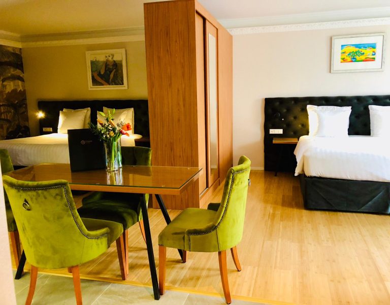 Chassé Residency picture of two-beds and table and cupboard Grand Deluxe Room